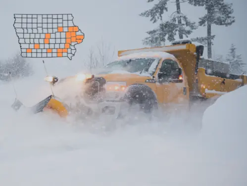 Snow plow pushing heavy amounts of snow, Map of 18 Iowa Counties including Adair, Black Hawk, Cedar, Clinton, Davis, Delaware, Dubuque, Jefferson, Johnson, Jones, Linn, Lucas, Montgomery, Polk, Scott, Story, Wapello, and Washington.