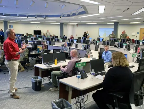 HSEMD team members have a discussion led by Director John Benson at the State Emergency Operations Center.