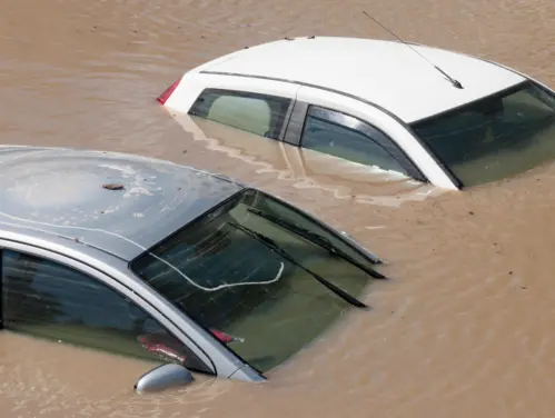 Cars surrounded by flood waters.