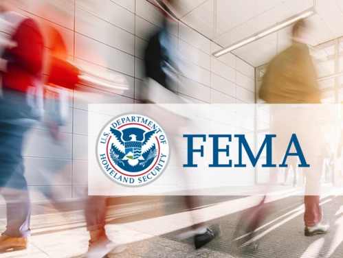 Students walking in hallway, FEMA logo