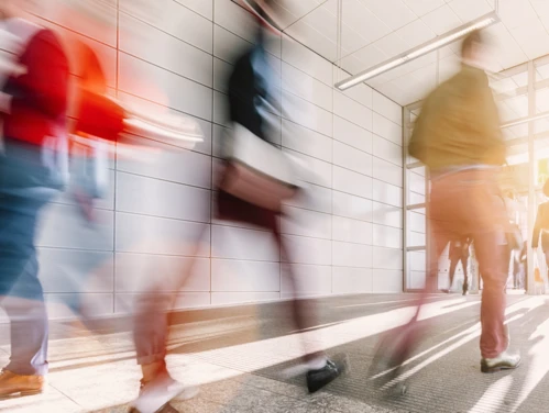 Blurry image of people walking in hallway.