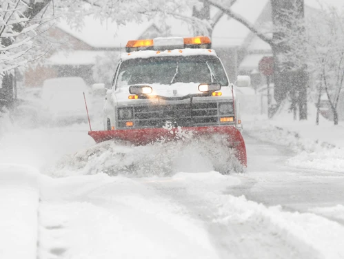 image of a snow plow on a snow covered street