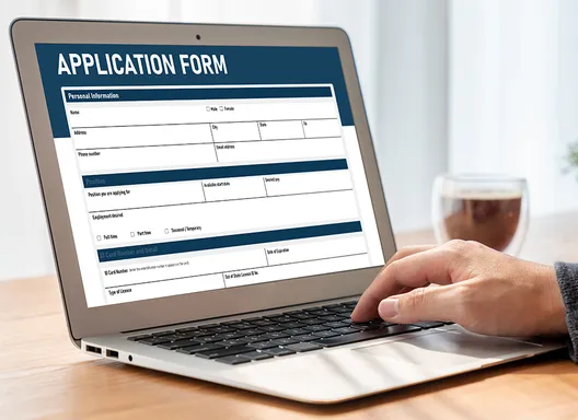Laptop with Application Form on screen.