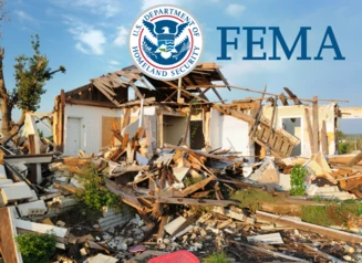 House stands severely damaged by a tornado. FEMA logo.