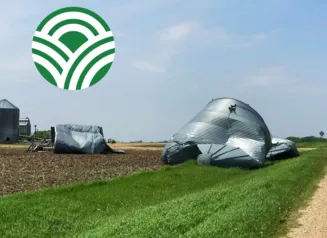 Grain bin damage in field due to severe storms. Iowa Dept. of Agriculture logo.