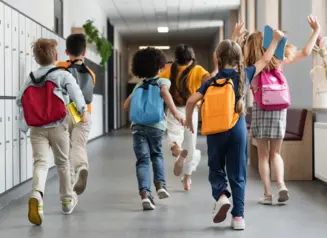 Kids running down school hallway.