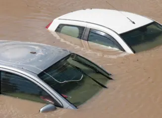 Cars surrounded by flood waters.