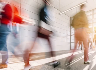 Blurry image of people walking in hallway.