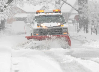 image of a snow plow on a snow covered street