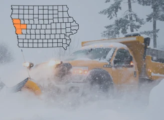 Snow plow moving through heavy snow. State of Iowa map with Crawford, Harrison, Monona, and Woodbury Counties selected.