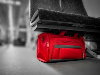 Red bag left behind under airport seats.